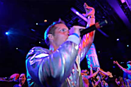 Brad Woodgate in times square with 3 young adults holding cans of Joyburst